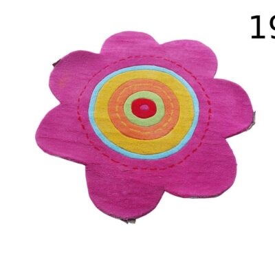 Decorative flower-shaped children's carpet in pink, yellow and orange tones for rent for events, advertising, films and series.