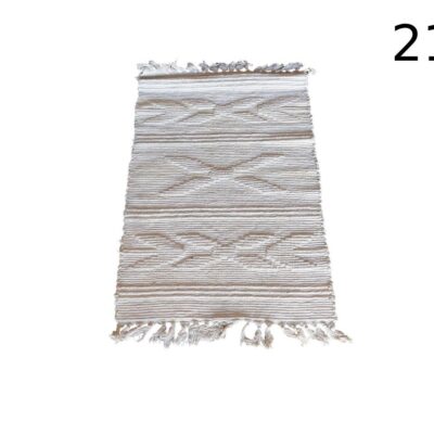 Beige cotton rug is an ideal decorative accessory to add warmth and texture to any corner of the home rental for events, advertising, films and series.
