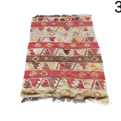 Vintage hand-woven Turkish Kilim rug with vibrant geometric patterns in red, beige and brown tones for rent for events, advertising, films and series.