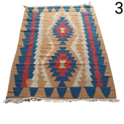 Turkish handmade kilim rug with traditional geometric pattern in blue, red and beige tones for rent for events, advertising, films and series.