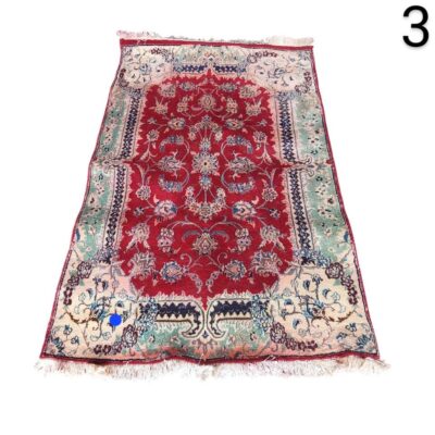Traditional Persian or Turkish carpet with a central medallion design, hand knotted and fringed at the ends for rent for events, advertising, films and series.