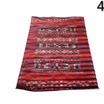 Moroccan red wool Kilim rug with tribal geometric patterns for rent for events, advertising, movies and series.