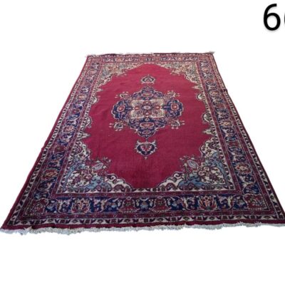 Persian vintage wool rug with a central medallion in red and navy blue tones for rent for events, advertising, films and series.