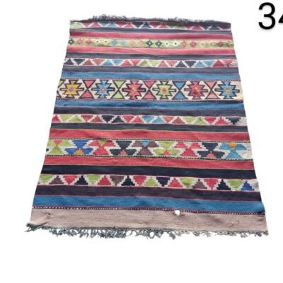 Vintage hand-woven wool Kilim rug with colourful geometric patterns for rent for events, advertising, films and series.