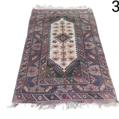 Handmade wool afghan rug with intricate geometric patterns and vibrant colours for rent for events, advertising, films and series.