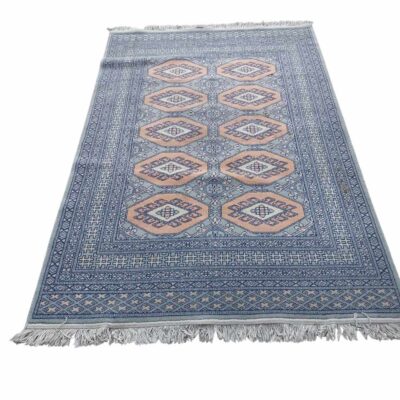 Persian style rug with a geometric design in pink and grey tones for rent for events, public events, films and series.