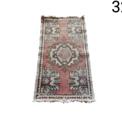 Small handmade Turkish wool rug with a geometric design in vintage aluiler style for events, advertising, films and series.