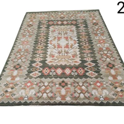 Hand-woven kilim carpet with traditional geometric patterns in green, beige and orange tones for rent for events, advertising, films and series.