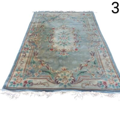 Traditional French Aubusson wool rug with floral motifs in pink, beige and green tones on a blue background for rent for events, advertising, films and series.