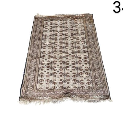 Handmade antique turkoman rug made with wool and vegetable dyes, characterised by a geometric design, for rent for events, advertising, films and series.