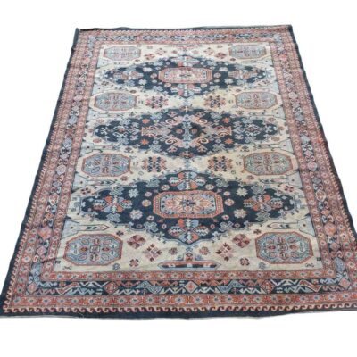 Vintage hand knotted wool rug with a traditional geometric pattern in blue, red and white for rent for events, advertising, films and series.